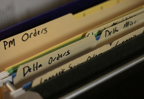 Organized filing cabinet with folder tabs